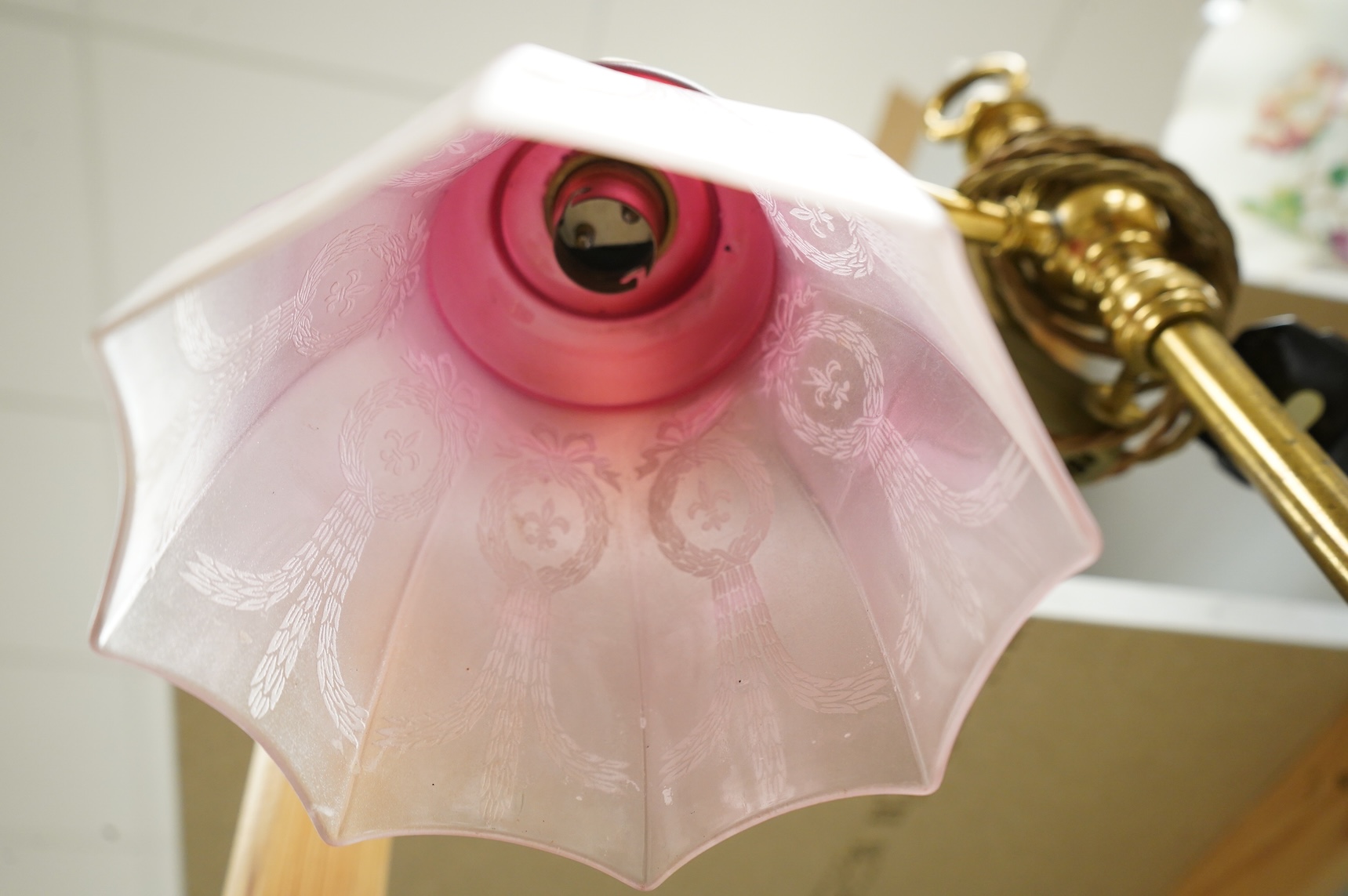 A late Victorian brass desk light with cranberry shade, 59cm